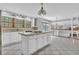 Bright kitchen features a center island with cooktop, tile floors, and backyard view at 5302 Greenway Dr, Villa Rica, GA 30180