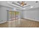 Spacious living room with hardwood floors, sliding glass doors to deck, and tray ceiling with fan at 5302 Greenway Dr, Villa Rica, GA 30180