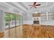 Bright living room boasts hardwood floors, fireplace, built-ins, and glass doors to a deck at 5302 Greenway Dr, Villa Rica, GA 30180