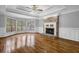 An airy living room features hardwood floors, fireplace, and large windows for natural light at 5302 Greenway Dr, Villa Rica, GA 30180