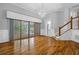 Hardwood floors gleam in the light-filled living room with sliding doors and wainscoting at 5302 Greenway Dr, Villa Rica, GA 30180