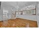 Large living room with hardwood floors, wainscoting, stairs, and a view to the kitchen at 5302 Greenway Dr, Villa Rica, GA 30180