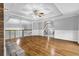 Spacious living room boasts hardwood floors, fireplace and detailed trim with staircase access at 5302 Greenway Dr, Villa Rica, GA 30180