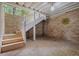 Enclosed patio with brick flooring, brick walls, and wooden stairs leading to an upper level at 5302 Greenway Dr, Villa Rica, GA 30180