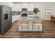 Bright kitchen with stainless steel appliances, granite countertops, and an island with barstools at 9458 Pinecrest Path # 317, Jonesboro, GA 30238