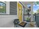Close-up of a cheerful yellow door, potted plants, and a welcoming porch at 183 Oak Dr, Atlanta, GA 30354