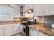 A close-up of a kitchen featuring granite countertops, stainless steel appliances, and white cabinets at 183 Oak Dr, Atlanta, GA 30354