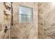 Close-up of a tiled shower featuring elegant fixtures and a window for natural light at 183 Oak Dr, Atlanta, GA 30354