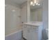 Well-lit bathroom featuring a tub-shower combo and a vanity with a large mirror at 1976 Deco Dr, Kennesaw, GA 30144