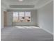Spacious bedroom featuring a trey ceiling, plush carpet and ample natural light from a large window at 1976 Deco Dr, Kennesaw, GA 30144