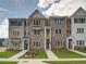 Modern townhome exterior showcasing brick facade, and manicured front lawn landscaping at 1976 Deco Dr, Kennesaw, GA 30144