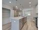 A spacious kitchen featuring an island with a sink, stainless steel appliances, and open layout at 1976 Deco Dr, Kennesaw, GA 30144
