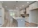 Bright kitchen features an island with pendant lights and modern appliances and opens to the living area at 1976 Deco Dr, Kennesaw, GA 30144