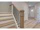 Beautiful staircase with light wood treads and a sleek black metal railing at 1976 Deco Dr, Kennesaw, GA 30144