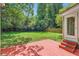 View of the backyard with red deck and lush landscaping at 2205 Desmond Dr, Decatur, GA 30033