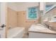 Bathroom featuring neutral tile, window and a tub at 2205 Desmond Dr, Decatur, GA 30033
