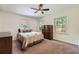 Cozy bedroom featuring neutral carpet, ceiling fan, and natural light from multiple windows at 2205 Desmond Dr, Decatur, GA 30033