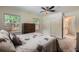 Carpeted bedroom featuring a ceiling fan, windows, closet, and an en suite bathroom at 2205 Desmond Dr, Decatur, GA 30033