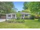Inviting single-story home featuring lush landscaping and a serene front yard at 2205 Desmond Dr, Decatur, GA 30033