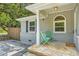 Cozy front porch with stone steps, columns and green chairs at 2205 Desmond Dr, Decatur, GA 30033