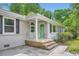 Cozy front porch with stone steps, columns and a light green door at 2205 Desmond Dr, Decatur, GA 30033
