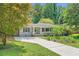 Charming home with a well-manicured lawn and a paved driveway at 2205 Desmond Dr, Decatur, GA 30033