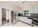 Modern kitchen featuring stainless steel appliances, light cabinets, and tiled flooring at 2205 Desmond Dr, Decatur, GA 30033