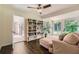 Bright sunroom with hardwood floors, built-in bookshelves, comfortable seating, and ample natural light at 2205 Desmond Dr, Decatur, GA 30033