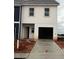 New construction home featuring a two-car garage and concrete driveway at 9462 Pinecrest Path # 319, Jonesboro, GA 30238