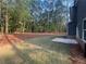 View of expansive backyard featuring newly laid sod and a treed backdrop at 142 Tye St, Stockbridge, GA 30281