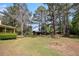 Expansive backyard showcasing mature trees, a shed, and partial view of the house at 2100 Ann Se Ct, Conyers, GA 30013