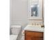 Charming powder room with a pedestal sink, decorative mirror, and beadboard paneling at 2100 Ann Se Ct, Conyers, GA 30013