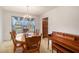 Cozy dining room featuring wood furniture, chandelier, and a view into backyard at 2100 Ann Se Ct, Conyers, GA 30013