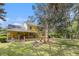 Charming yellow house with a spacious yard and beautiful mature trees at 2100 Ann Se Ct, Conyers, GA 30013