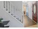 Bright foyer with wood-look flooring, white staircase, and view of the main bathroom at 2100 Ann Se Ct, Conyers, GA 30013