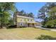 Inviting two-story home with yellow siding, stone accents, front porch and attached garage at 2100 Ann Se Ct, Conyers, GA 30013