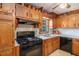 Efficient kitchen with wooden cabinets, black appliances, and lots of storage space at 2100 Ann Se Ct, Conyers, GA 30013