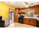 Functional kitchen featuring wooden cabinets, black appliances and a view into dining room at 2100 Ann Se Ct, Conyers, GA 30013