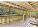 Open porch with seating area, featuring a view of the wooded backyard at 2100 Ann Se Ct, Conyers, GA 30013