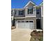 Modern townhome exterior with attached two car garage at 329 Elgin Dr # 157, Lawrenceville, GA 30045