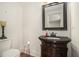 Charming half-bathroom with a pedestal sink, dark wood cabinets, and classic fixtures at 387 Nickajack Se Rd, Mableton, GA 30126