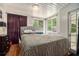 Cozy bedroom with a patterned bedspread, natural light, and a private balcony entrance at 387 Nickajack Se Rd, Mableton, GA 30126