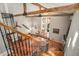Elegant foyer with exposed wood beams, hardwood floors, and a decorative wrought iron staircase at 387 Nickajack Se Rd, Mableton, GA 30126