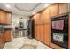 Bright kitchen featuring custom wood cabinets, black appliances and a decorative tile floor at 387 Nickajack Se Rd, Mableton, GA 30126