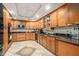 Open kitchen featuring custom wood cabinets, black appliances, and granite countertops at 387 Nickajack Se Rd, Mableton, GA 30126
