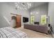 Open bedroom and living space with a barn door, fireplace, and abundant natural light at 387 Nickajack Se Rd, Mableton, GA 30126