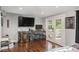 Well-lit living room featuring hardwood floors and access to outdoor balcony at 387 Nickajack Se Rd, Mableton, GA 30126