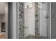 Modern shower with pebble accents and white tile, offering a spa-like experience at 387 Nickajack Se Rd, Mableton, GA 30126