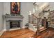 Detailed view of the staircase with hardwood floors and a fireplace at 387 Nickajack Se Rd, Mableton, GA 30126