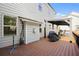Back deck with grill, umbrella and patio table under a metal gazebo for outdoor living and entertaining at 410 Crestbrook Ln, Dallas, GA 30157